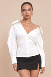 Main Character Puff Sleeve Top front view, white off-shoulder collared button-front top with puff sleeves and fitted waist, styled with a black mini skirt