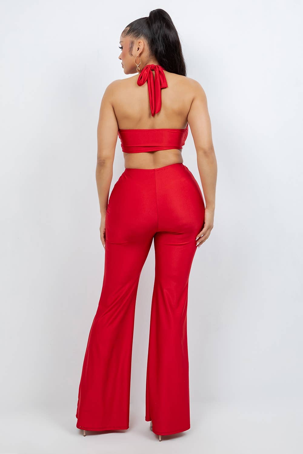 Back view of red stretch halter jumpsuit from She Rare Boutique