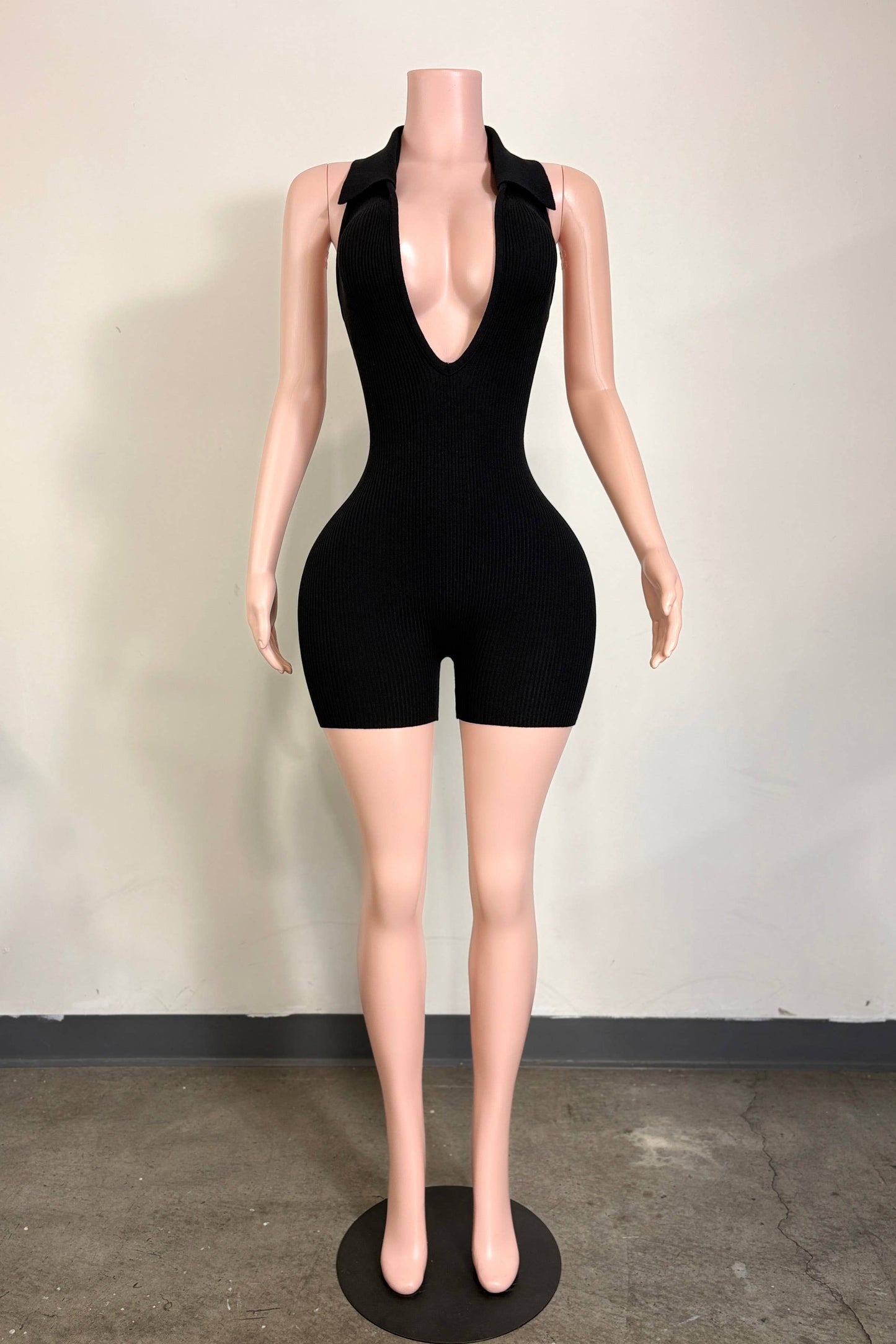 Worth the Wait black rib knit romper with deep V neckline from She Rare Boutique